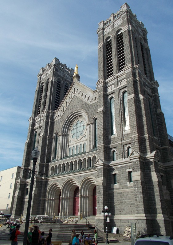 A large church with a clock on the front of it in quebec city