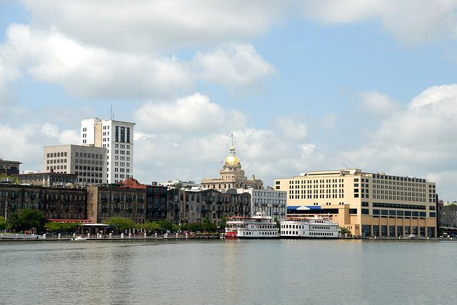 A large body of water with savannah in the background