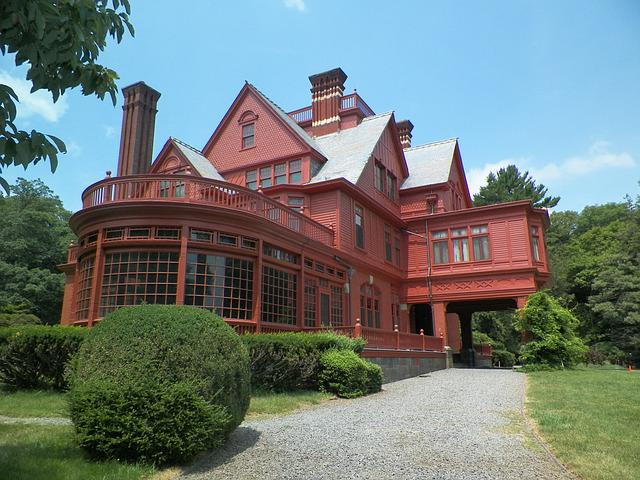 A large red house is surrounded by trees and bushes in Thomas Edison National Historic Park