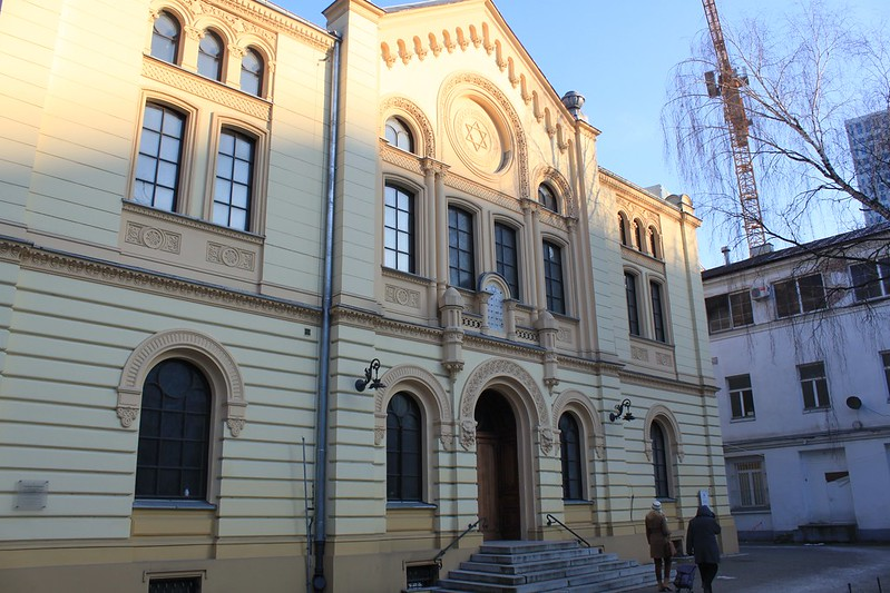 A large yellow building with a jewish star on the top of it in the warsaw ghetto