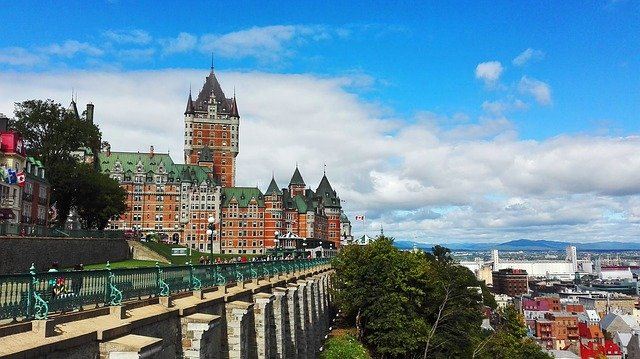 A large castle is sitting on top of a hill overlooking quebec city.