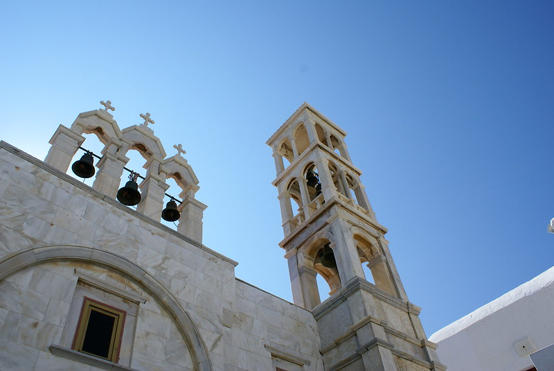 The Monastery Of Panagia Tourliani with a bell tower on top of it