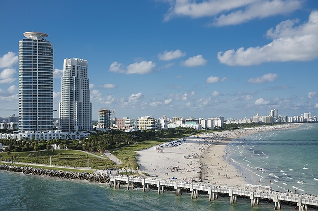 An aerial view of a beach with miami in the background