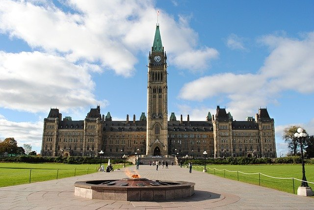 A large building with a clock tower in front of it