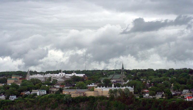 Levis city surrounded by trees and buildings under a cloudy sky