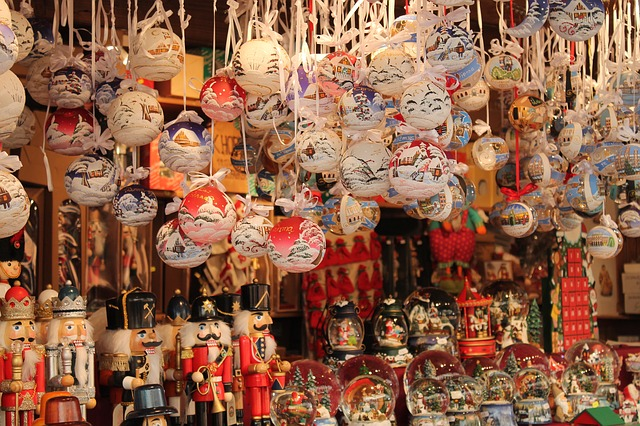 A bunch of christmas decorations are hanging from the ceiling in hamburg christmas market stall