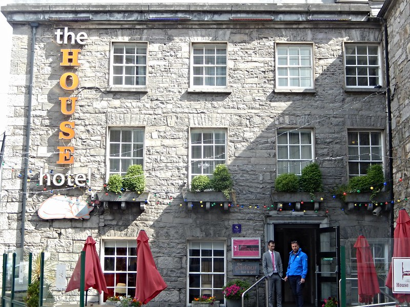Two men are standing outside of the house hotel in Galway