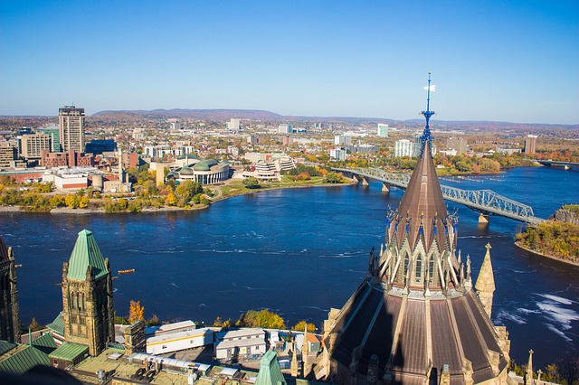 An aerial view of Ottawa with a river and a bridge in the background.