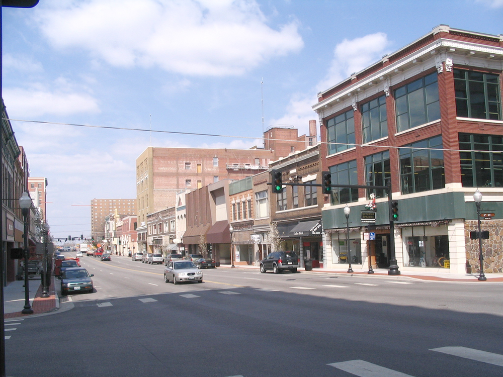 Cars are driving down a street in the small town of joplin