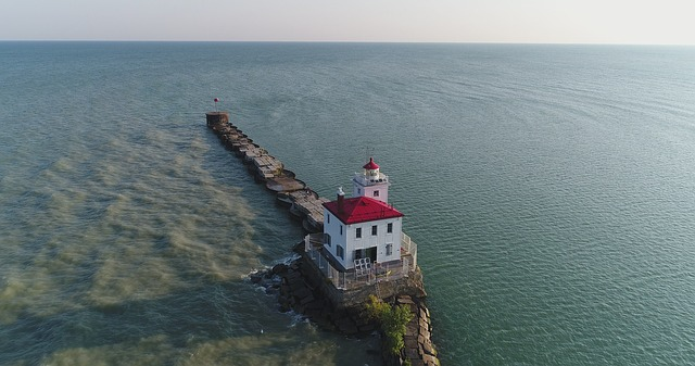 An aerial view of a lighthouse on a small island in the middle of lake erie