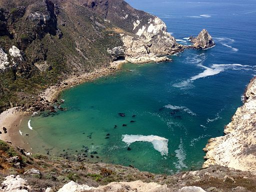 A large body of water surrounded by mountains and cliffs