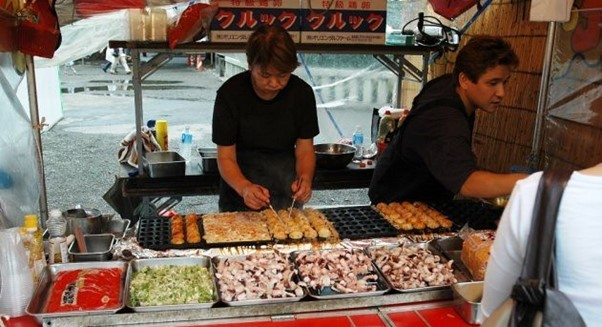 Two men are preparing food in Tokyo