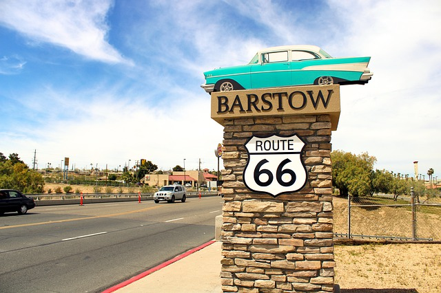 A sign for Barstow with Route 66 and a car on top of it