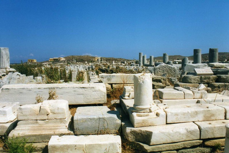 A cemetery with a blue sky in the background on the island of delos
