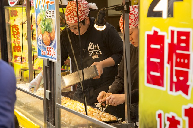 A group of people are cooking street food in a food truck in tokyo