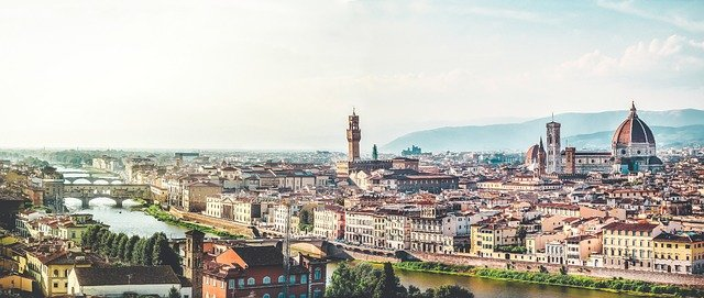 An aerial view of a Tuscany city with a river running through it.