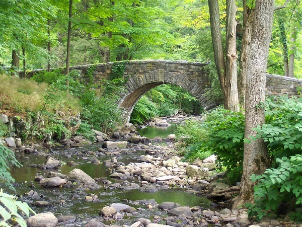 A stone bridge over a stream in Rockefeller State Park