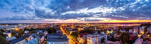 An aerial view of portland at night with a sunset in the background.