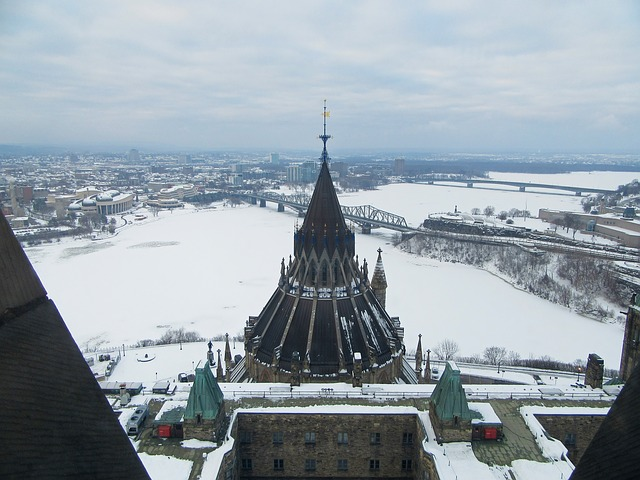 An aerial view of a snowy Ottawa with a large building in the foreground