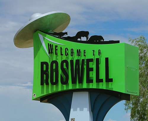 A green sign that says welcome to Roswell
