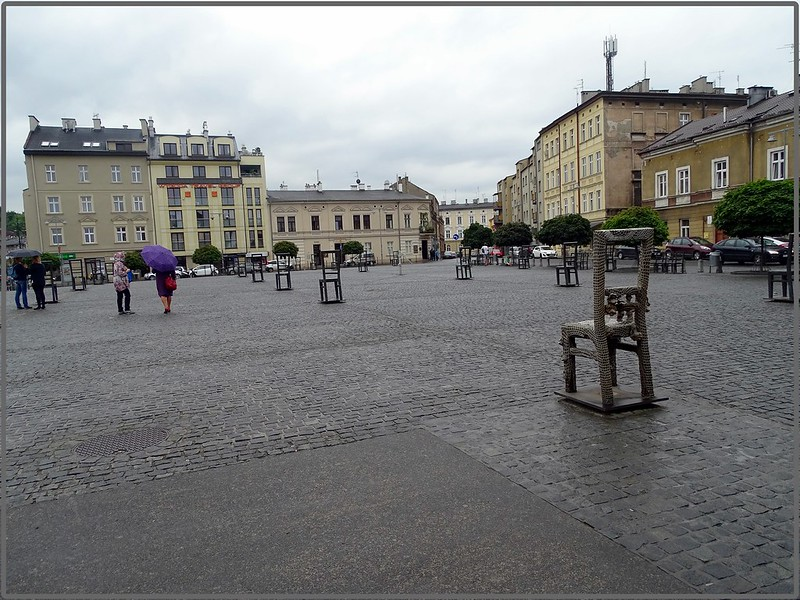 A statue of a chair in the middle of a square in Krakow stands as a holocaust memorial