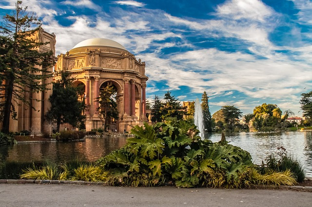 A large building with a fountain in front of it and a pond in front of it in San Francisco