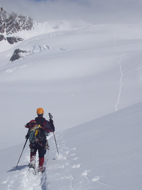 A person is skiing down a snow covered slope