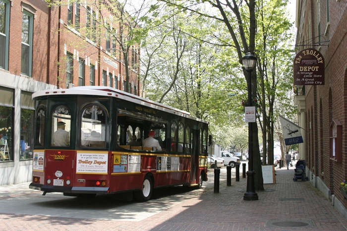 A salem trolly car is parked on the side of a street