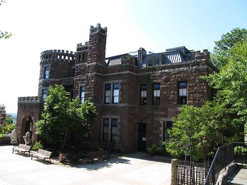 A large brick building with trees in front of it in the Garret Mountain Reservation