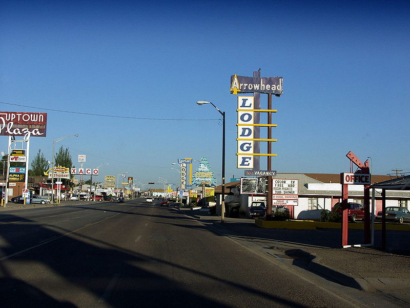 A motel with a sign that says lodge on it in Gallup