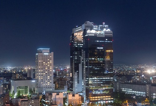 The Osaka skyline at night with the Umeda Sky building in the foreground