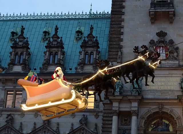 Santa claus in a sleigh is flying over a building in the hafencity market