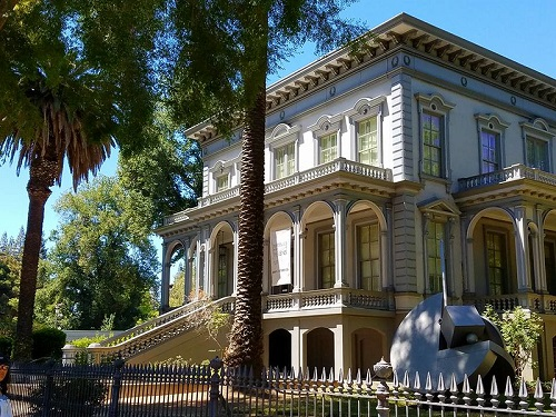 A large house with a palm tree in front of it in Sacramento