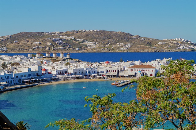 A large body of water with Mykonos in the background