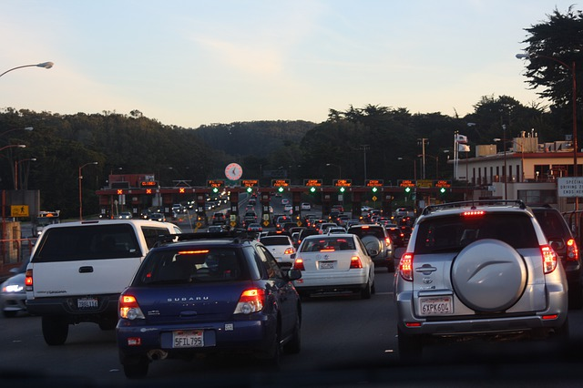A lot of cars are driving down a busy highway