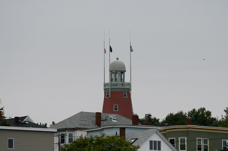 the portland observatory with flags on top of it