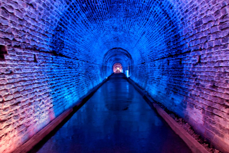 The brockville railway tunnel with blue and purple lights on the walls.