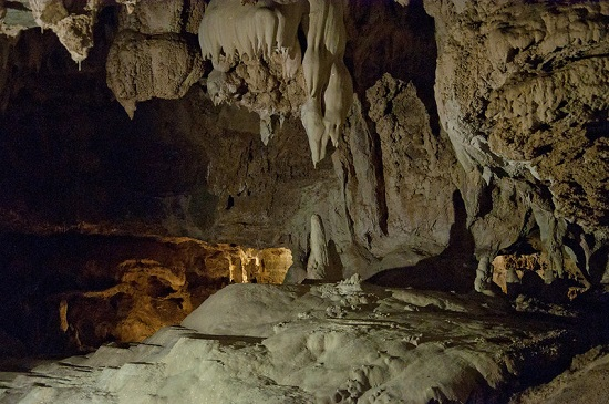 A cave with a lot of rocks and stalactites hanging from the ceiling in sequoia np