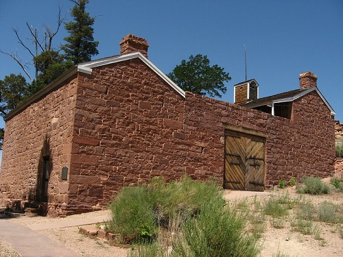 A brick building with a wooden door and a chimney in the Kaibab Indian Reservation