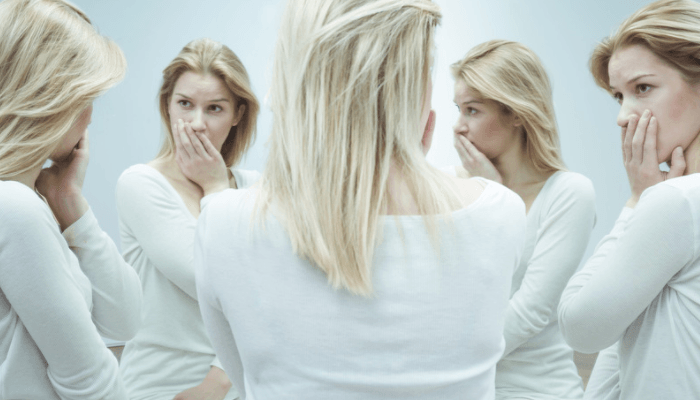 woman looking at herself in a five-way mirror