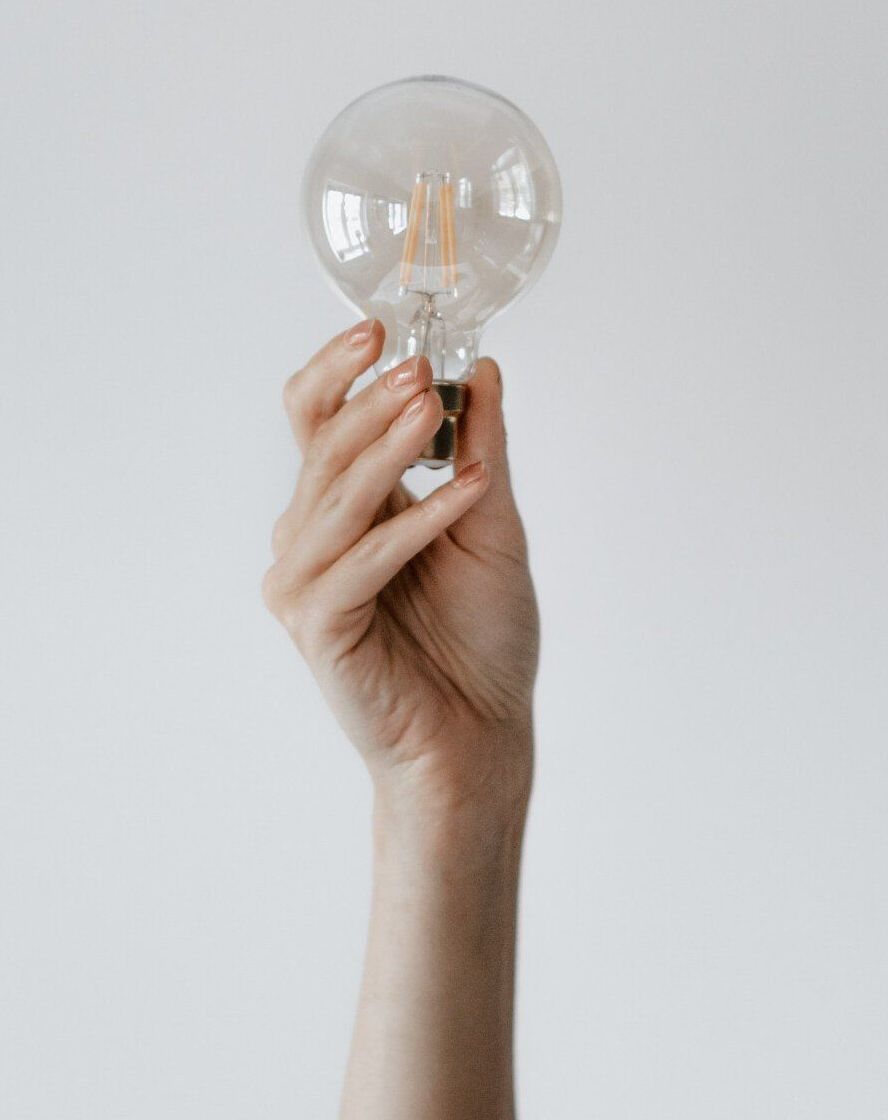 Hand holding old-fashioned lightbulb