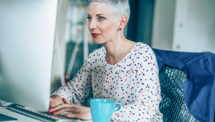 modern female professional reading at her desk on PC