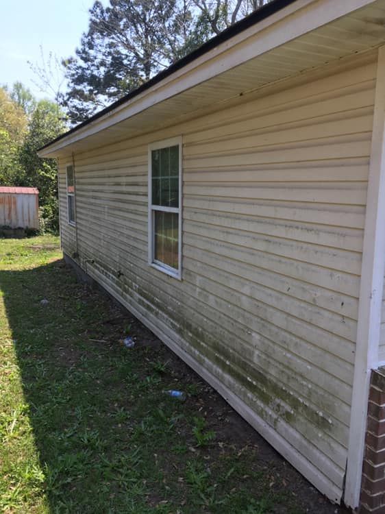 The side of a house with a lot of moss on it.