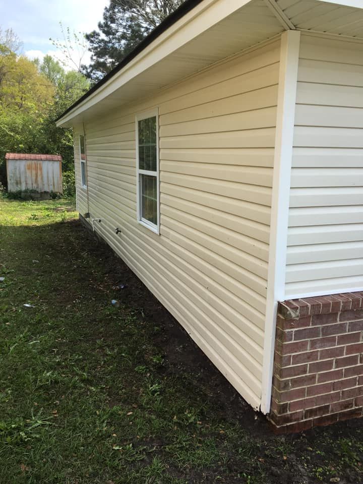 The side of a house with white siding and a window.