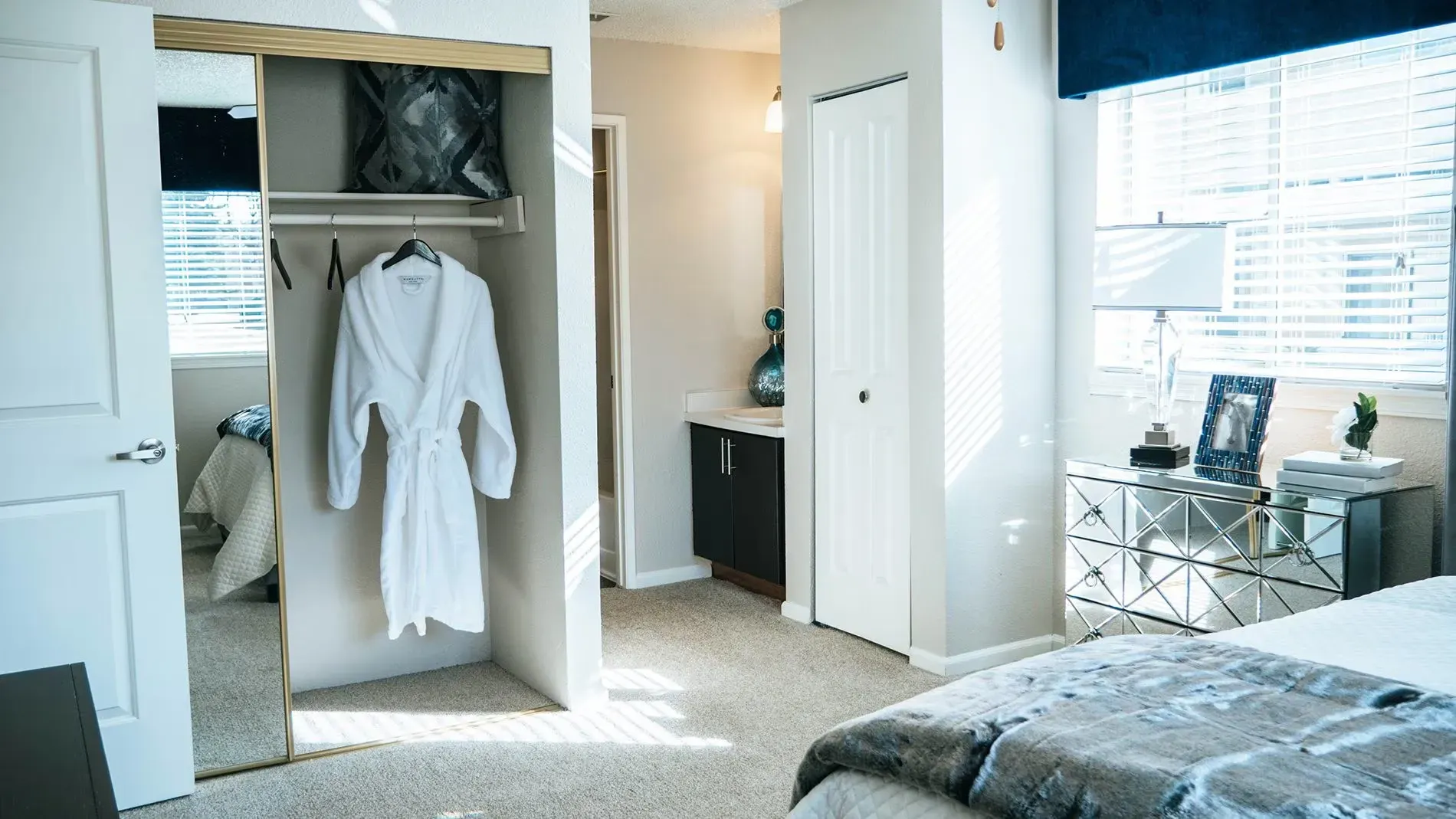 Bedroom interior with a closet, robe, and a bed at Westward Heights in Denver, CO.