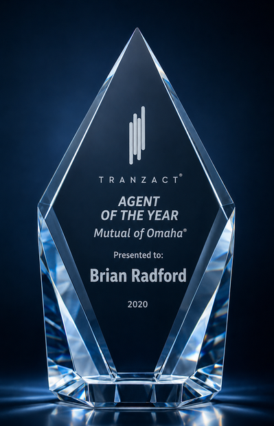Transparent glass award plaque on dark blue background reading “Agent of the Year” for Brian Radford.