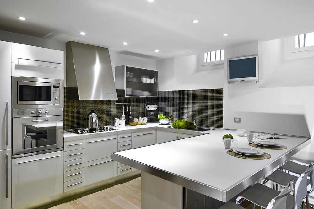 A Kitchen With White Cabinets and Stainless Steel Appliances — Gavin Cummings Kitchens in Dubbo, NSW