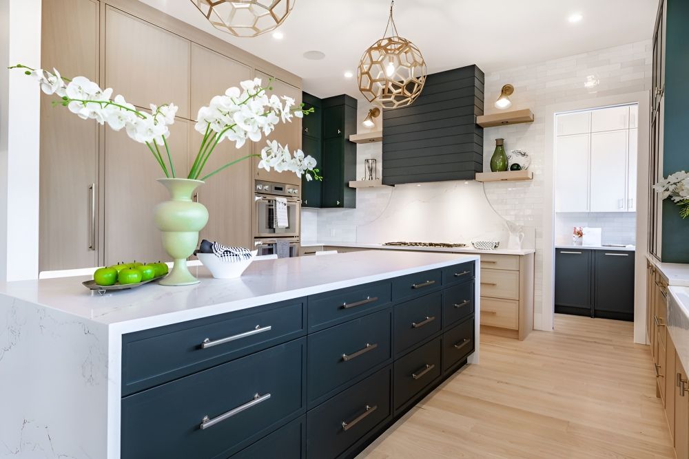 A Kitchen With A Large Island And A Vase Of Flowers On The Counter — Gavin Cummings Kitchens in Gilgandra, NSW
