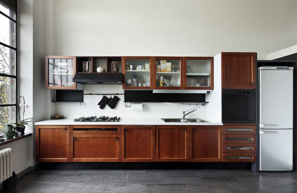 A Kitchen With Wooden Cabinets and a White Refrigerator — Gavin Cummings Kitchens in Dubbo, NSW