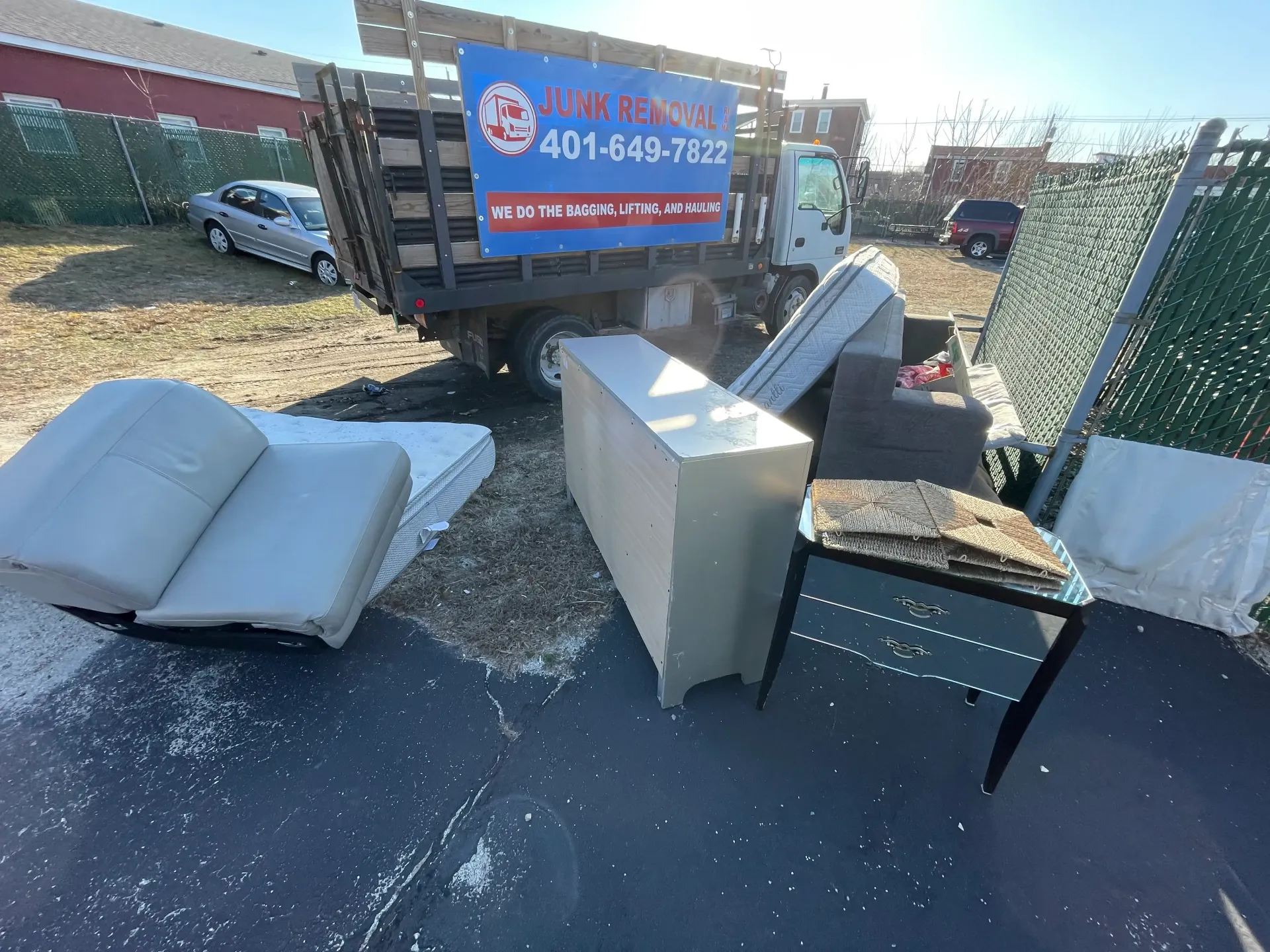 picture of piles of cardboard boxes with a rolled up carpet next to them